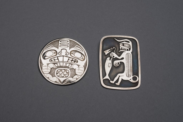 A silver brooch with a beaver motif (left), circa 1954, and a silver brooch with a halibut-fisherman motif (right), circa 1955—both created by renowned Haida artist Bill Reid—are part of a collection donated to the Museum of Anthropology by late Calgary philanthropist Margaret (Marmie) Perkins Hess. Credit: Martin Dee/University of British Columbia