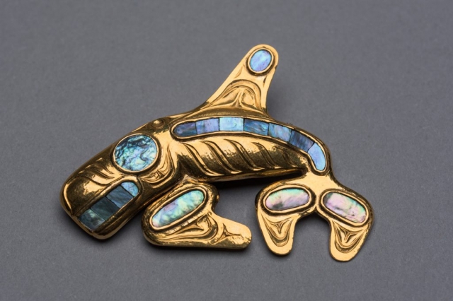 A gold-and-abalone brooch with killer-whale motif, circa 1959-1960, by renowned Haida artist Bill Reid is part of a collection donated to the Museum of Anthropology by late Calgary philanthropist Margaret (Marmie) Perkins Hess. Credit: Martin Dee/University of British Columbia