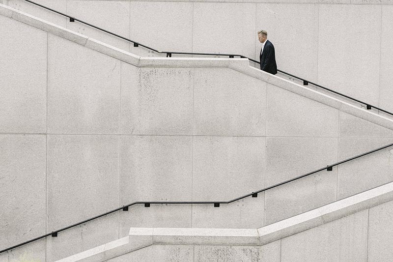 Man ascending the stairs in an office building