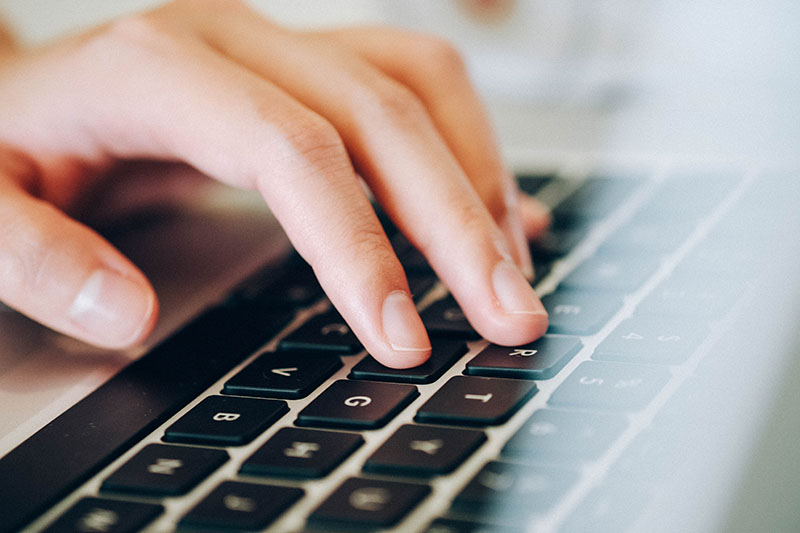 Closeup of fingers on a laptop keyboard