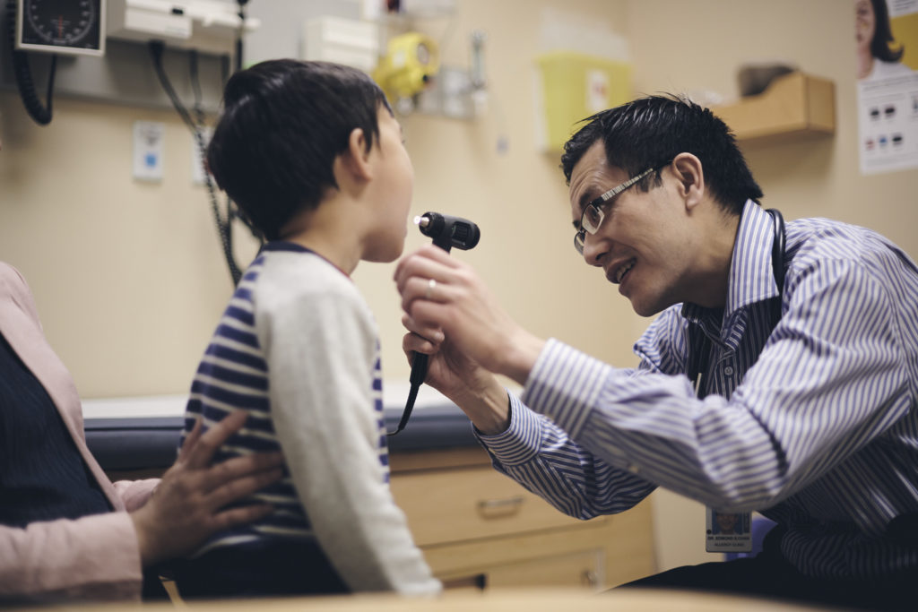 Dr. Edmond Chan provides care to a young patient