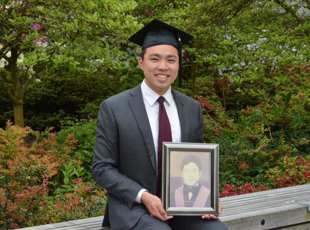 UBC engineering physics Tyler Lum holding a framed photo of his uncle.
