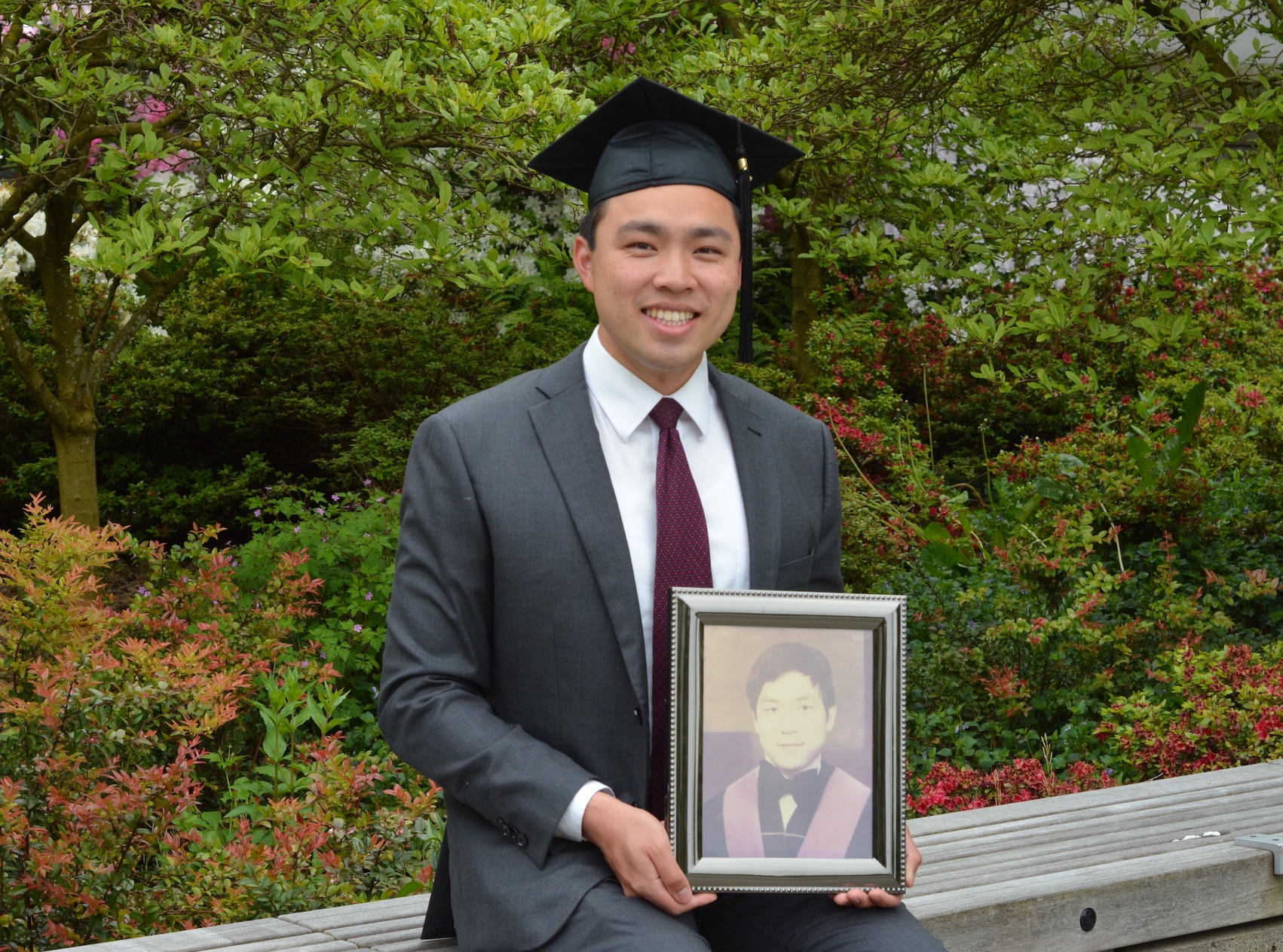 UBC engineering physics Tyler Lum holding a framed photo of his uncle.