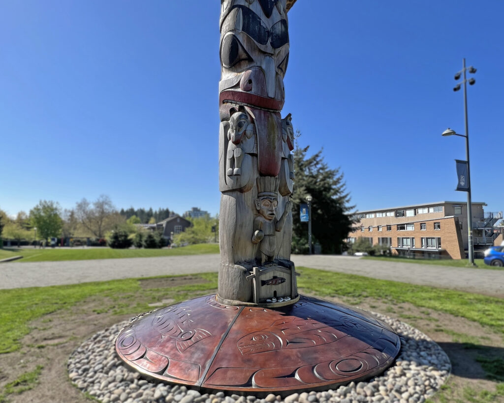 The Reconciliation Pole anchored by the 15-foot-wide disc depicts four salmon.