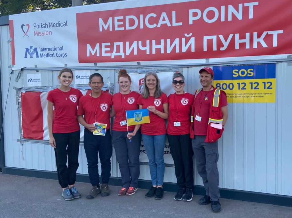 Six members of the Canadian Medical Assistance Team standing infront of a makeshift medical centre in Ukraine. UBC's Dr. Hubert Chao (second from left) and Dr. Luba Butska (third from right) are part of this team.