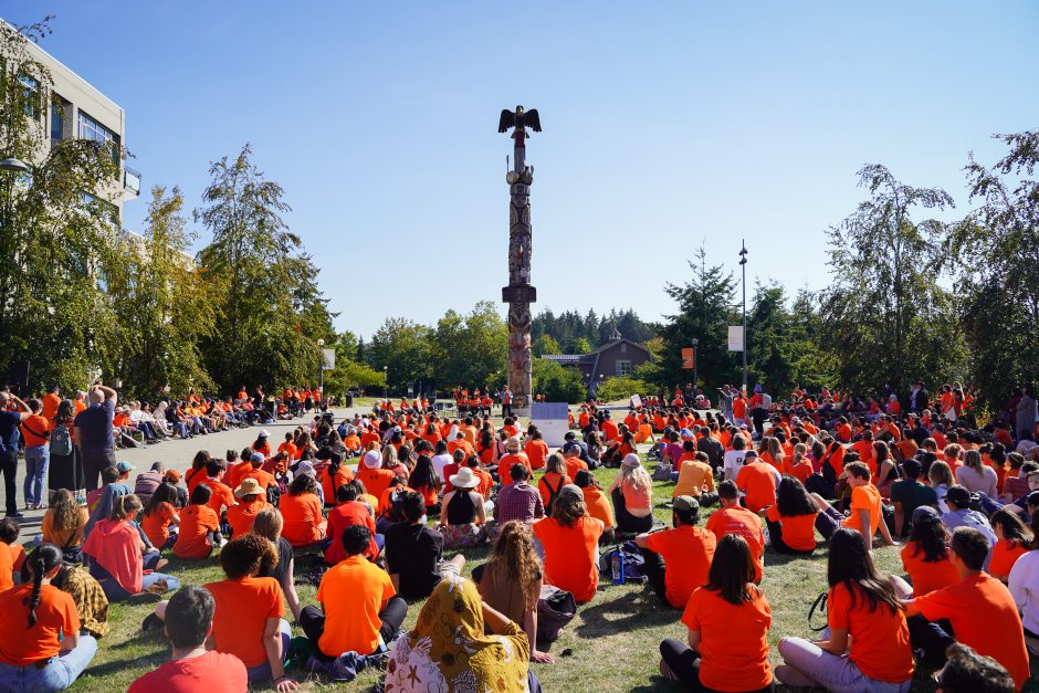 Crowd gathered in front of the Reconciliation Pole at UBC for Orange Shirt Day 2022.