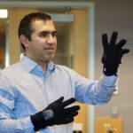 UBC electrical and computer engineering professor Dr. Peyman Servati demonstrating the smart glove. Photo credit: Lou Bosshart/UBC Media Relations