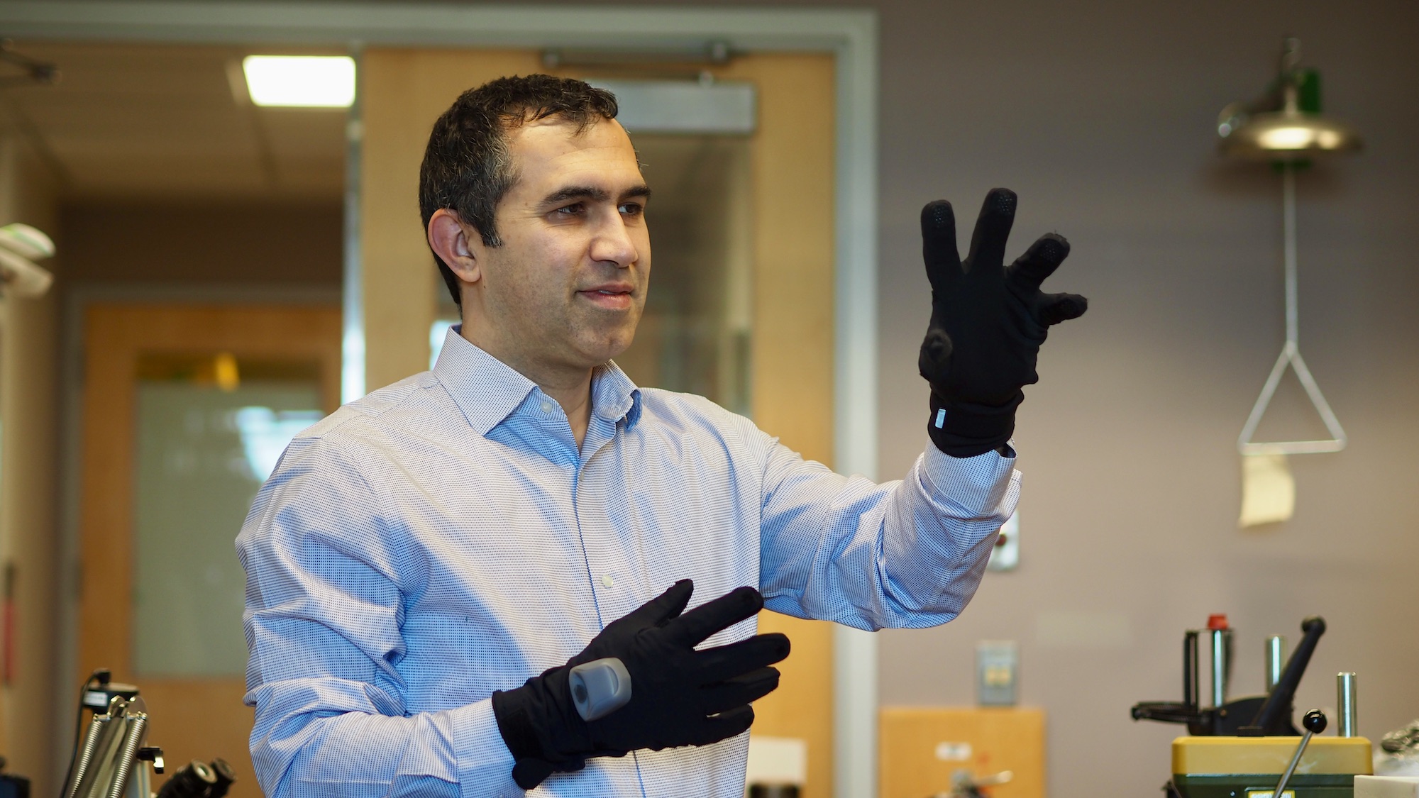 Dr. Peyman Servati pictured demonstrating the smart gloves being worn on him.