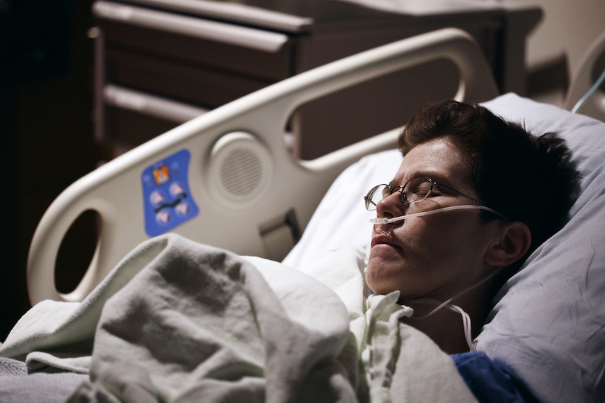 Person lying in a hospital bed