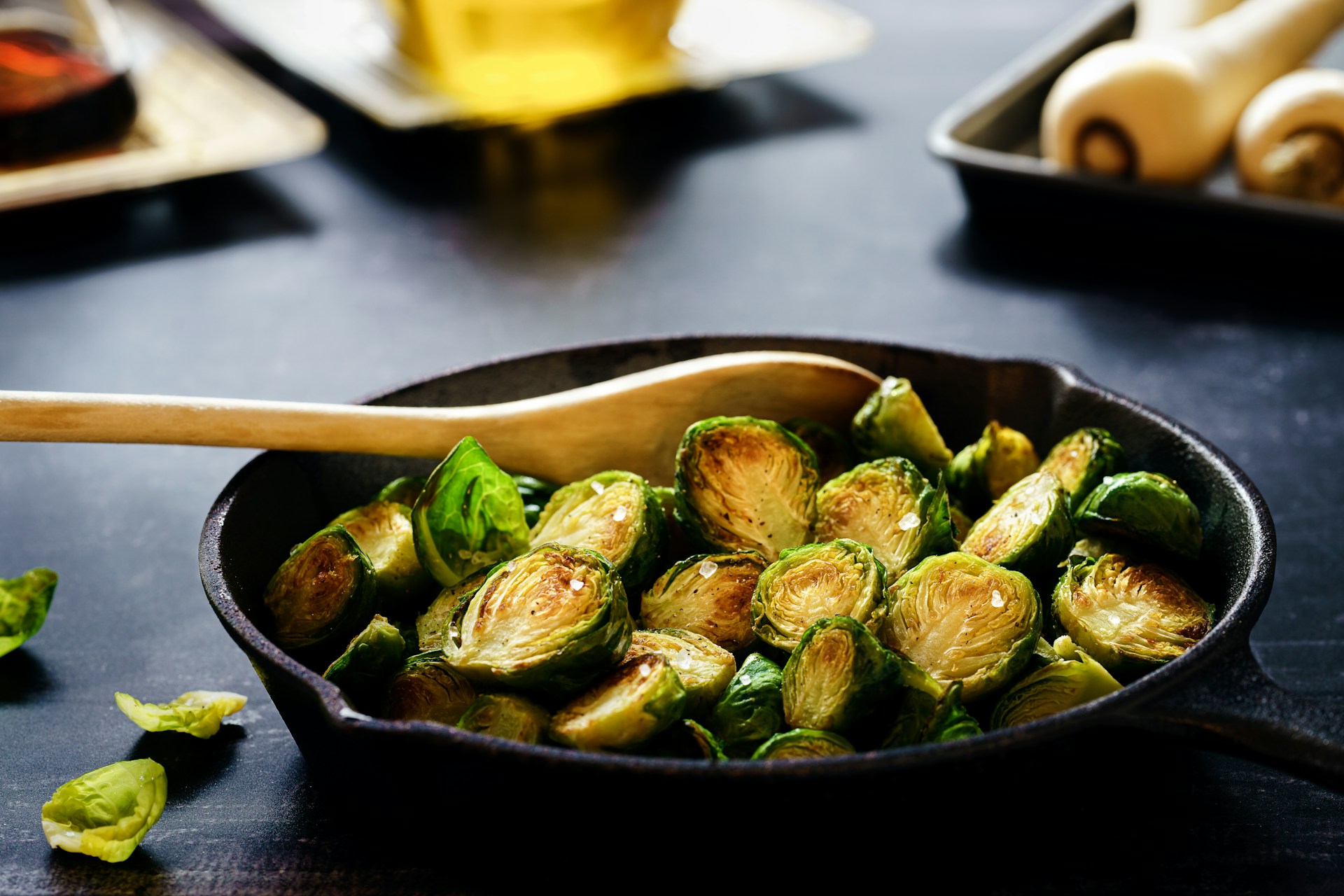 A plate of cooked brussel sprouts in a cast iron pan